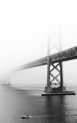 A black-and-white photograph of San Francisco’s Bay Bridge.